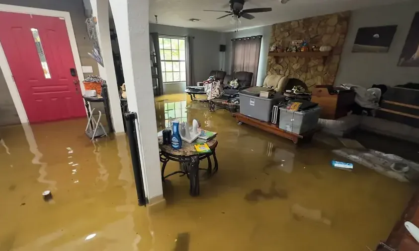 Floodwater covers a furnished living room floor