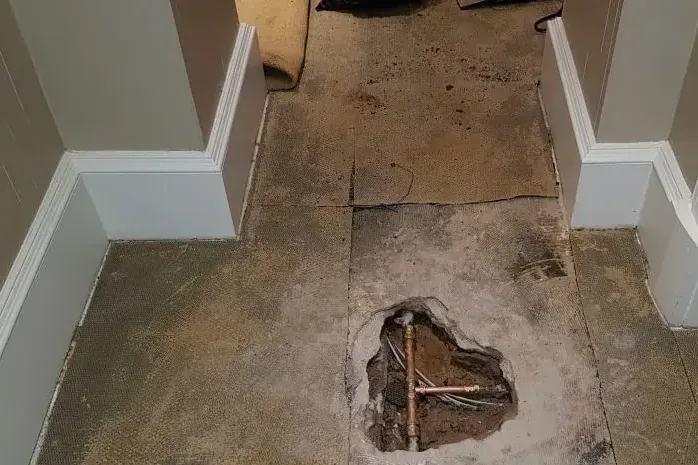 An opening in the floor exposes the structure beneath a hallway